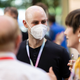 Attendees wearing face mask mingle with those without facial coverings